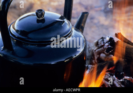 https://l450v.alamy.com/450v/aecwpr/close-up-of-black-coffee-kettle-on-burning-camp-fire-boiling-water-aecwpr.jpg