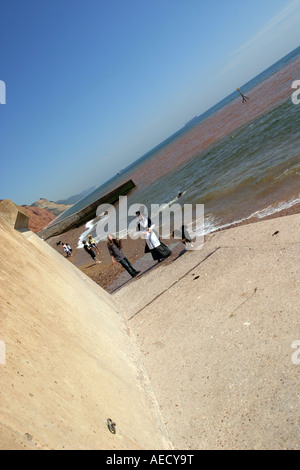 Girl dressed in traditional Welsh costume seafront Sidmouth Devon UK Stock Photo