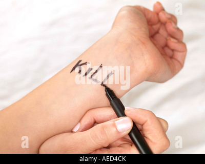 Teenage Girl Writing on her Wrists Model Released Stock Photo