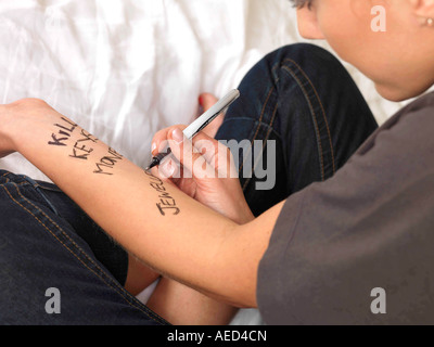 Teenage Girl Writing on her Wrists Model Released Stock Photo