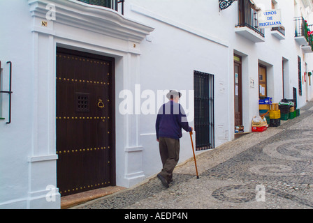 Man walking with a cane on scenic street in Frigiliana Spain Stock Photo