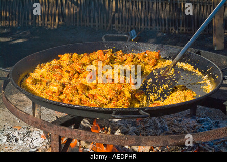 Huge pan of paella being cooked over an open fire on Burriana Beach in Nerja Spain Stock Photo