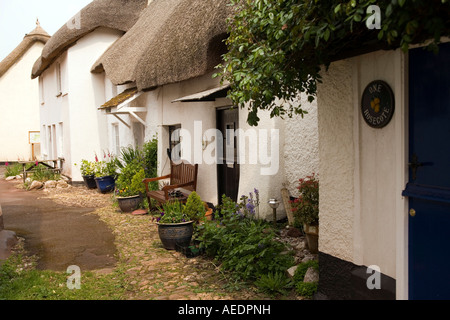 UK Devon Inner Hope front porch of thatched cottage in the village square Stock Photo