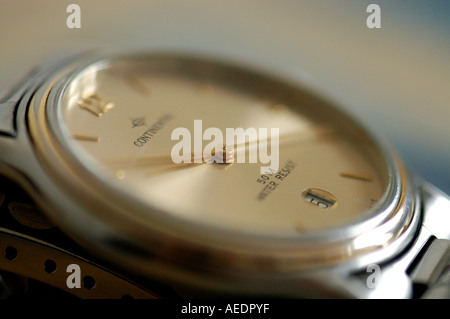 watch time piece titanium sapphire hour minute second date day luminous hand finger elapsed steel red background back ground Stock Photo