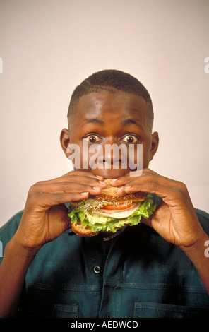 Young black man eating a sandwich St Paul Minnesota Stock Photo