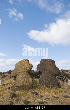 Two carved figures, or moai, toppled from their platform on Easter Island. Stock Photo