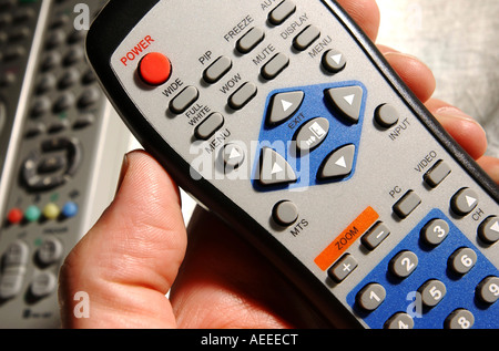 Remote control held in hand Stock Photo