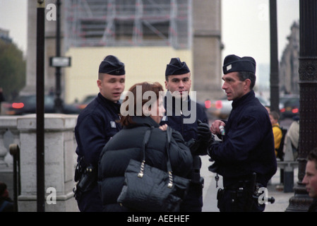Police officers on duty on the Champs-Élysées in Paris France Stock Photo