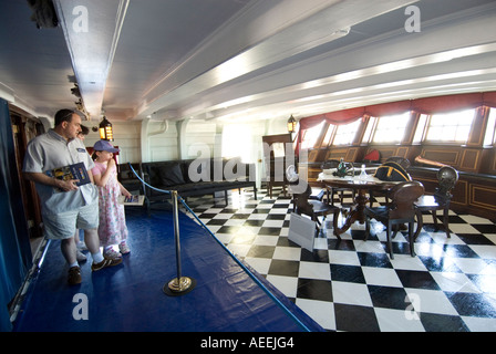 Visitors in the Captain's Day Cabin on the HMS Victory, England UK Stock Photo