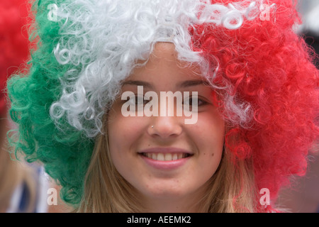 Female Italian football fan wearing a wig in her national colours Stock Photo