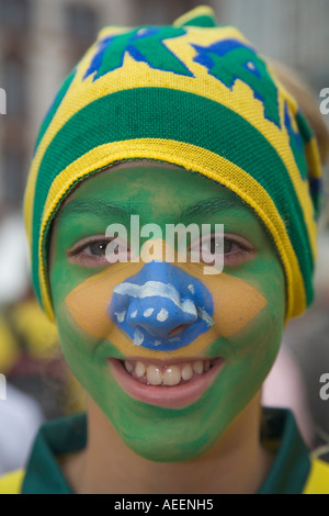 A young fan of the Brazilian national football team with a make-up in the Brazilian colours Stock Photo