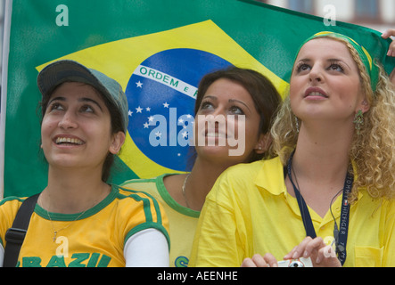 Three female Brazilian football fans viewing the world cup match Brazil vs Ghana (3:0) at a public viewing event in Dortmund Stock Photo