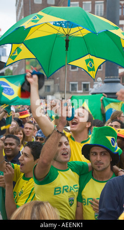 Brazilian football fans watching the world cup match Brazil vs Ghana (3:0) at a public viewing event in Dortmund in German rain Stock Photo