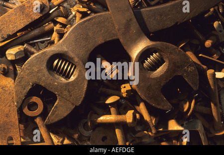 large adjustable spanners laying on pile of rusting nuts and bolts