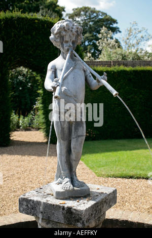 Stone garden statue of Pan playing his pipes Stock Photo