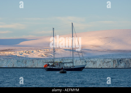 sailboat in glacial waters along the western Antarctic peninsula Antarctica Southern Ocean Stock Photo