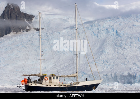 steel sailboat Golden Fleece in glacial waters along the western Antarctic peninsula Antarctica Southern Ocean Stock Photo