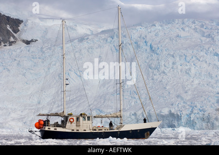 steel sailboat Golden Fleece in glacial waters along the western Antarctic peninsula Antarctica Southern Ocean Stock Photo