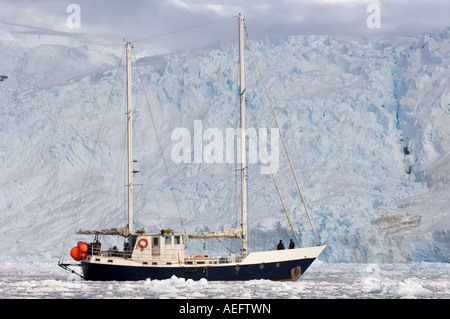 steel sailboat Golden Fleece in glacial waters along the western Antarctic peninsula Antarctica Southern Ocean Stock Photo