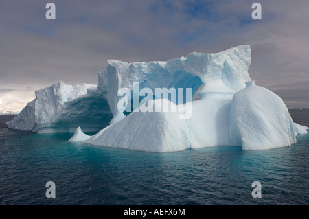 arched iceberg floating off the western Antarctic peninsula Antarctica Southern Ocean Stock Photo