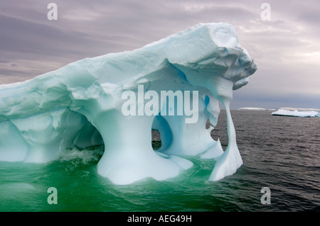 Arched Iceberg Floating Off The Western Antarctic Peninsula Antarctica arched-iceberg-floating-off-the-western-antarctic-peninsula-antarctica