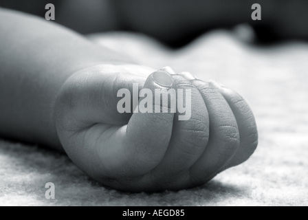 Baby s World baby s fingers lying small cute rosy fist hand wrist sleeping bed resting person people kid child baby Stock Photo