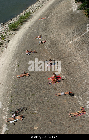 People sunbathing along the Danube riverside Budapest Hungary Stock Photo