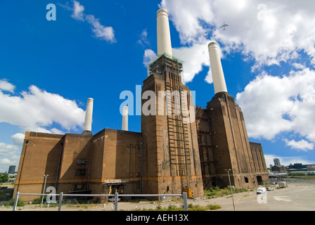 Horizontal wide angle of the empty shell of Battersea Power Station against a bright blue sky. Stock Photo