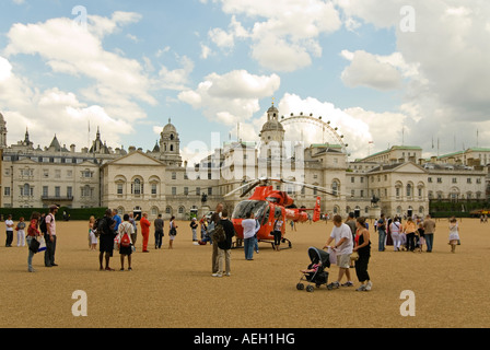 Horizontal wide angle of London's Air Ambulance landed at Horse Guards Parade in an emergency with interested onlookers Stock Photo