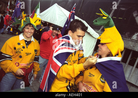 Australia rugby fans draped in Australian flags and wearing a wallabies hat in Cardiff for an international match Stock Photo