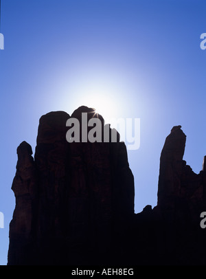 Sunburst over rock formation Monument Valley AZ Stock Photo