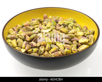 Bowl Full Of Healthy Vegetarian Ripe Roasted Green Pistachio Nuts Against A White Background With No People And A Clipping Path Stock Photo