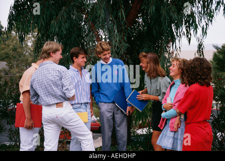 Caucasian California Teens hanging out Teenage boys and girls conversing talking blue red clothes school books   MR ©Myrleen Pearson Stock Photo