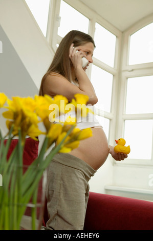 Pregnant woman using telephone Stock Photo