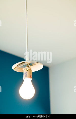 Light Bulb Hanging From White Cord Stock Photo