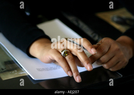 Young African American womans hands holding a pen Stock Photo