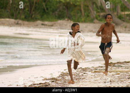 Two black young dominican boys swimming in the sea and jumping like a ...