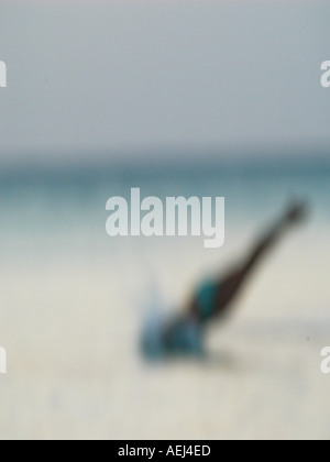 Woman in swimsuit diving into sea Stock Photo