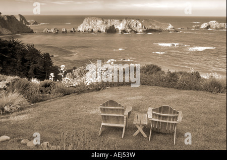 Two chairs on grass overlook at The Harbor House Inn Elk California Stock Photo