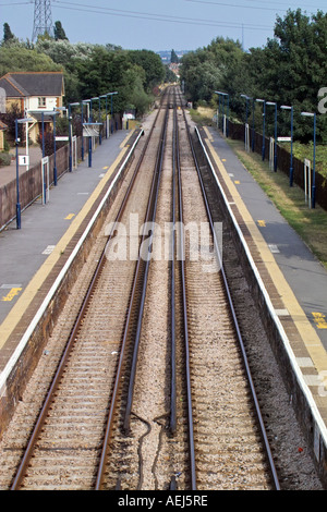 Empty railway tracks converging into the distance with wooden sleepers ...