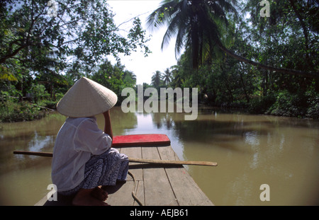 Woman wearing traditional straw hat in boat Mekong Delta Vietnam Stock Photo