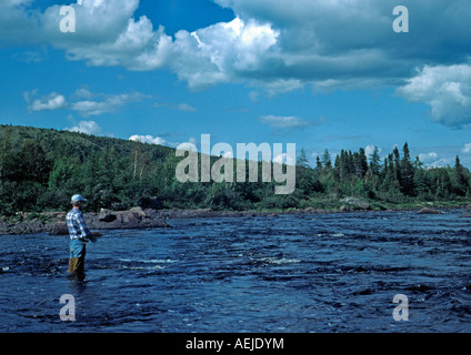 Woman fly fishing in Salmon River near the town of Main Brook