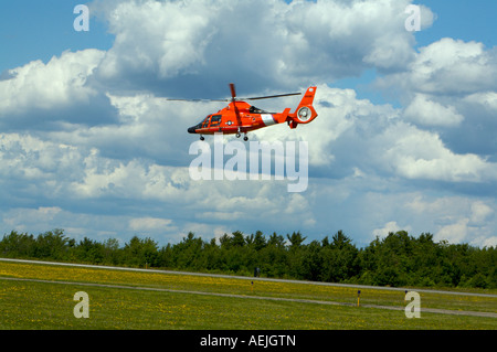 A US Coast Guard HH 65B SAR Helicopter demonstrates a search and rescue mission at Binghamton Airshow New York Stock Photo