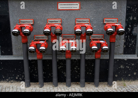 Red Fire Hydrant With Hose Connected To Outlet Stock Photo