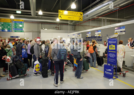 Passengers waiting at the check in on the airport Frankfurt-Hahn, Rhineland-Palatinate, Germany, Europe Stock Photo