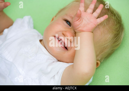 A tired 10 month old baby girl Stock Photo
