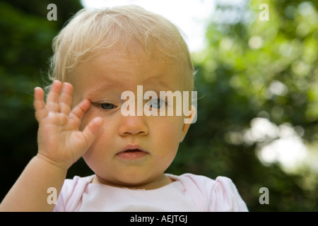 A tired 10 month old baby girl Stock Photo