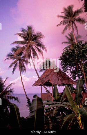 The Village Hotel thatch roofed gazebo and view from bar at dusk Pohnpei Micronesia Stock Photo