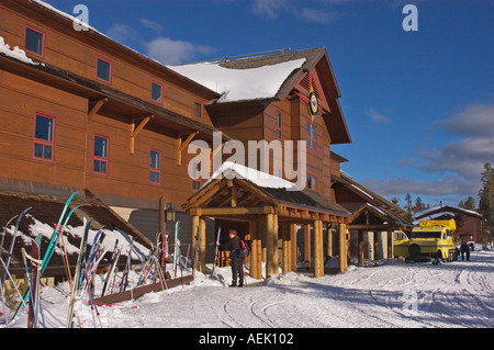 Old Faithful Snow Lodge in winter with snow coach and skis at entrance Yellowstone National Park Wyoming USA Stock Photo