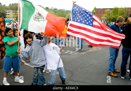 Mexican American kids age 11 marching in parade with American and Mexican flags, Cinco de Mayo Fiesta. 'St Paul' Minnesota USA